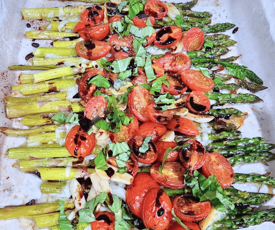 Sheet pan roasted asparagus with garlic, tomatoes, and bubbly mozzarella makes a colorful, comforting side