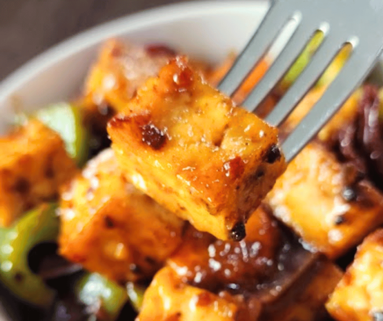 Crispy baked tofu tossed in a sweet and spicy peanut sauce with colorful stir fried vegetables.