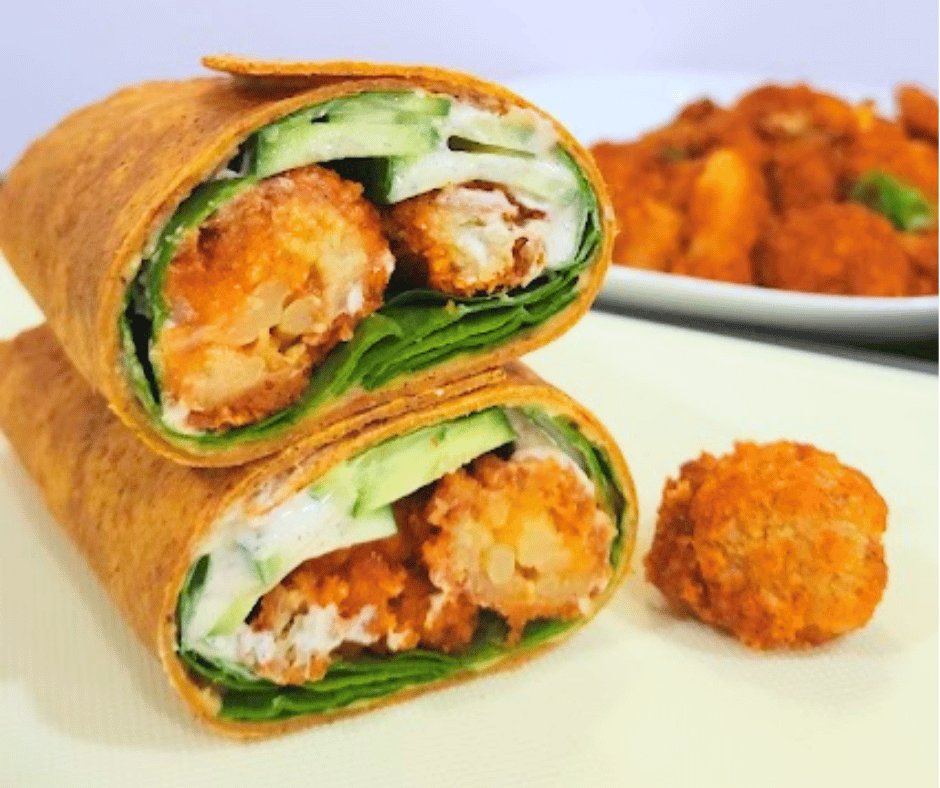 Crispy buffalo cauliflower wrapped in soft tortillas with cool hummus and crunchy veggies