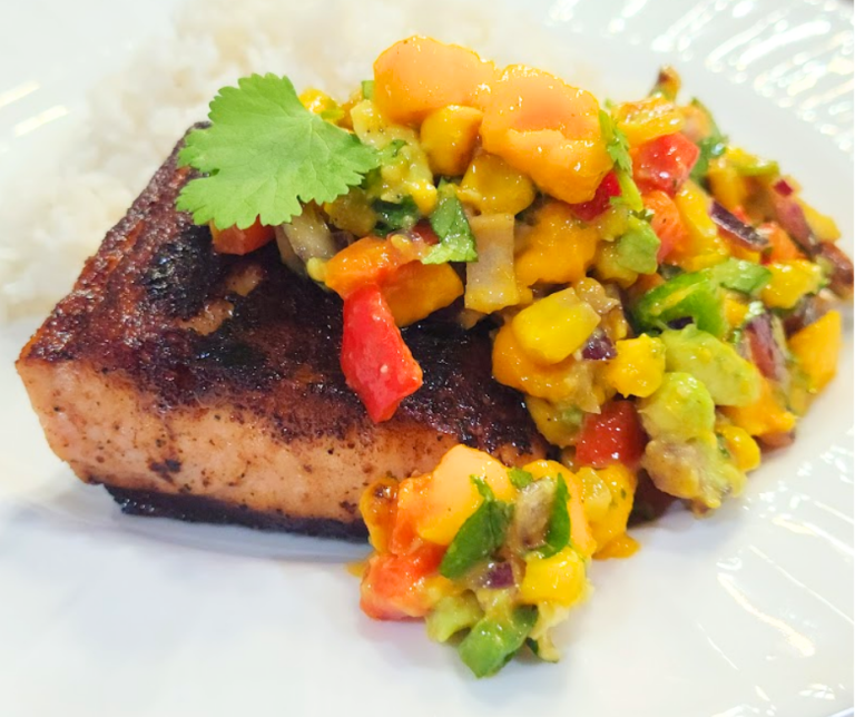 Crispy-edged salmon with a spoonful of juicy mango salsa on top