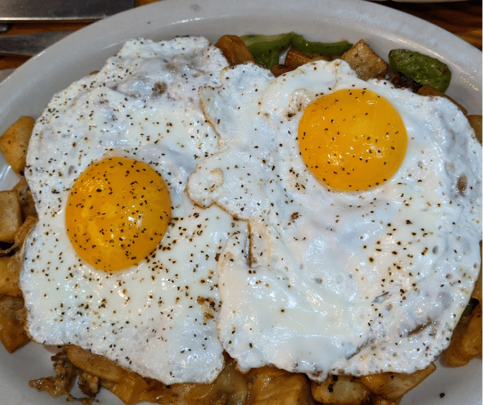 Herbed Potato Hash with Eggs cooked until golden and ready to serve.