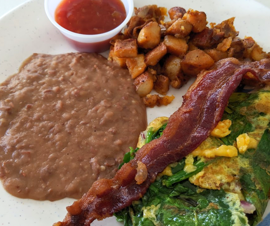 Crispy breakfast potatoes with smoky spices and creamy refried beans on the side just make sense together.