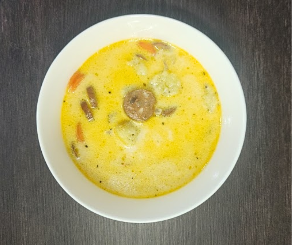 Creamy Italian Sausage Soup with Crispy Gnocchi Croutons, loaded with sausage, onions, and carrots in a creamy, spiced broth